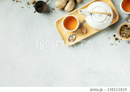 Minimalist Herbal Tea Flat Lay with White Teapot and Ginger Minimalist Herbal Tea Flat Lay with White Teapot and Ginger 139111819
