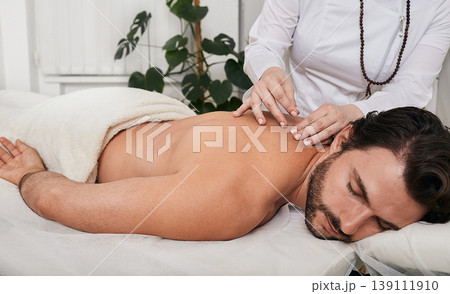 Alternative medicine, reflexology. Treatment of back pain and tightness with acupuncture needles for a male patient, Traditional Chinese Medicine Alternative medicine, reflexology. Treatment of back pain and tightness with acupuncture needles for a male patient, Traditional Chinese Medicine 139111910