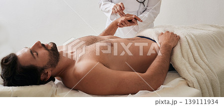 Chiropractor inserts acupuncture needle into man's hand. Acupuncture treatment, reflexology, alternative medicine Chiropractor inserts acupuncture needle into man's hand. Acupuncture treatment, reflexology, alternative medicine 139111934