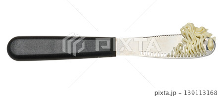 Special butter knife with shavings of butter on the blade, isolated background Special butter knife with shavings of butter on the blade, isolated background 139113168