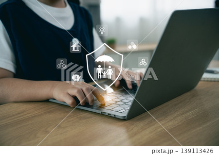 Person Using Laptop with Digital Family Protection Icons and Symbols Overlaid in a Modern Workspace Setting Person Using Laptop with Digital Family Protection Icons and Symbols Overlaid in a Modern Workspace Setting 139113426