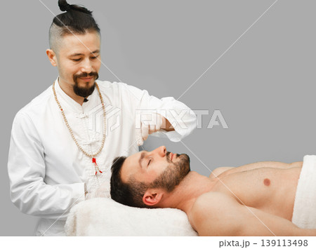 Man enjoys the acupuncture procedure. Acupuncturist doing acupuncture very accurately Man enjoys the acupuncture procedure. Acupuncturist doing acupuncture very accurately 139113498