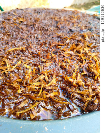 Close up view of wet shredded organic mulch soaking in a pool of dark liquid Close up view of wet shredded organic mulch soaking in a pool of dark liquid 139113636