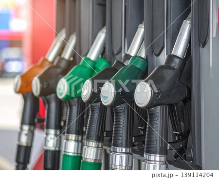 Fuel nozzles line up in a petrol station dispenser 139114204