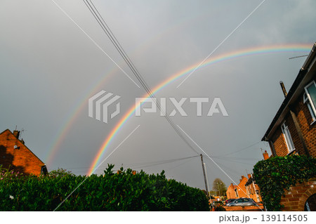 Double rainbow on a gray sky after rain and storm. Real rainbow after rain on a spring day. 139114505