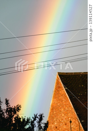 Double rainbow on a gray sky after rain and storm. Real rainbow after rain on a spring day. 139114527