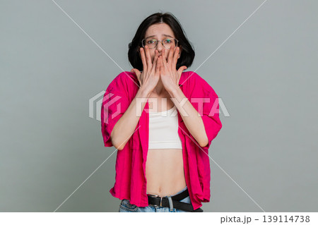 Woman shivering looking around anxiously hugging shoulders expressing fear worry nervous feeling Woman shivering looking around anxiously hugging shoulders expressing fear worry nervous feeling 139114738