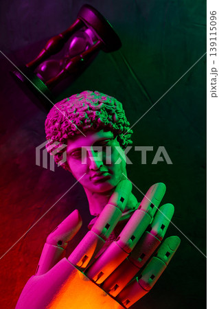 Classical sculpture with hourglass and robotic hand illuminated by neon pink and green lighting Classical sculpture with hourglass and robotic hand illuminated by neon pink and green lighting 139115096