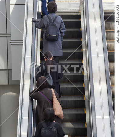 名古屋駅前の商業施設のエスカレーターに登る通勤中の若い女性会社員の姿 名古屋駅前の商業施設のエスカレーターに登る通勤中の若い女性会社員の姿 139116935