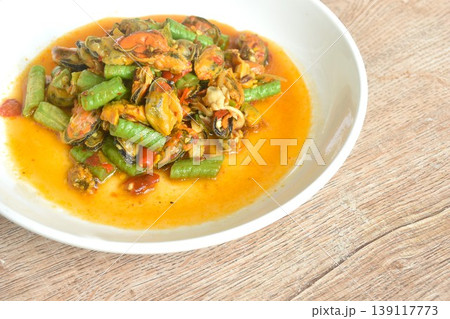 spicy stir fried slice yard long bean with mussel and basil leaf on plate spicy stir fried slice yard long bean with mussel and basil leaf on plate 139117773