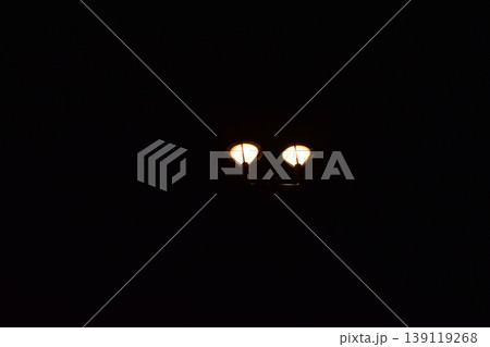 Close-up of the street light at night. City street lamp post in the street at night. Cityscape and lighting scene. Close-up of the street light at night. City street lamp post in the street at night. Cityscape and lighting scene. 139119268