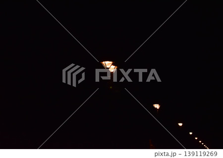 Close-up of the street light at night. City street lamp post in the street at night. Cityscape and lighting scene. 139119269