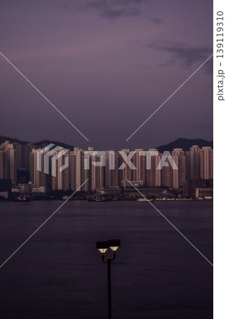 Close-up of the streetlight at the sunset with buildings in the background, City lamppost in the street with cityscape background. Cityscape and downtown scene. Close-up of the streetlight at the sunset with buildings in the background, City lamppost in the street with cityscape background. Cityscape and downtown scene. 139119310