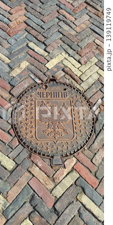 A city mine hatch with Chernihiv city symbol. Decorative hatch. Symbolic object A city mine hatch with Chernihiv city symbol. Decorative hatch. Symbolic object 139119749