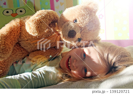 Little girl playing with teddy bear. Summer vacation with beloved dog Little girl playing with teddy bear. Summer vacation with beloved dog 139120721