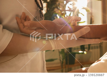 Chiropractor inserts acupuncture needle into patient's hand. Acupuncture treatment, reflexology, alternative medicine Chiropractor inserts acupuncture needle into patient's hand. Acupuncture treatment, reflexology, alternative medicine 139120887