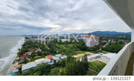 High Angle View of Coastal City Skyline with Tropical Beach and Mountains under Cloudy Sky High Angle View of Coastal City Skyline with Tropical Beach and Mountains under Cloudy Sky 139121327