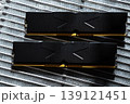 Black DDR5 RAM memory modules placed on a aluminum radiator. RAM shortages on the market, rising prices, and increased demand driven by the growing need for AI training. 139121451