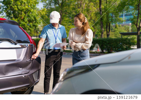 Female driver and insurance agent discussing a car accident Female driver and insurance agent discussing a car accident 139121679