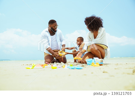 Happy Family Playing with Sand Toys on Sunny Beach Summer Vacation 139121703