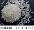 Raw rice in a black bowl Isolated on a blur background. 139121768
