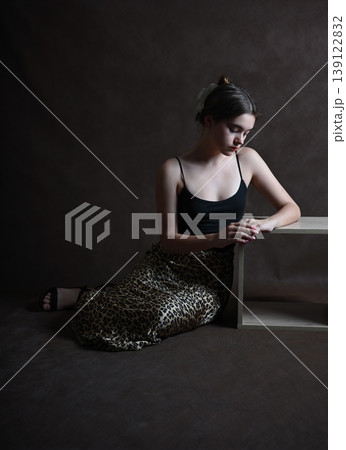 Teenage girl with dark hair poses in the studio Teenage girl with dark hair poses in the studio 139122832