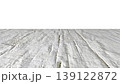 Perspective view of a flat wooden surface with a pronounced texture and annual rings. 139122872