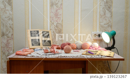 handicraft desk in a home interior with various yarn threads handicraft desk in a home interior with various yarn threads 139123267