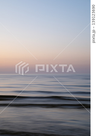 A dreamy, impressionistic paint like blurred sea sunset background with gently soft pastel colours. Vertical photo. A dreamy, impressionistic paint like blurred sea sunset background with gently soft pastel colours. Vertical photo. 139123690