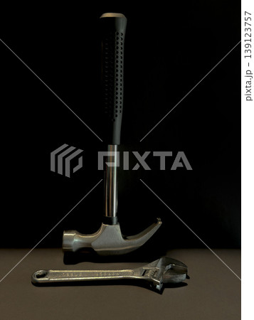 Hammer and Adjustable Wrench on Dark Background DIY Repair Tools Construction Maintenance Workshop Equipment Home Improvement Hardware Flat Lay Close Up Hammer and Adjustable Wrench on Dark Background DIY Repair Tools Construction Maintenance Workshop Equipment Home Improvement Hardware Flat Lay Close Up 139123757