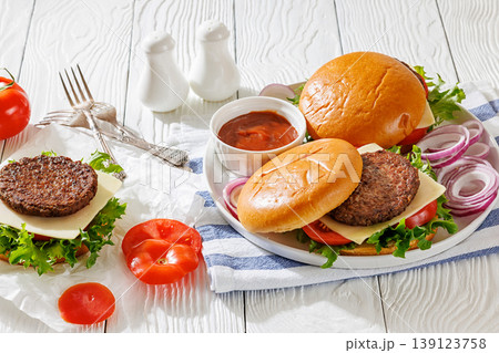 Beef cheeseburgers with brioche buns on a plate Beef cheeseburgers with brioche buns on a plate 139123758