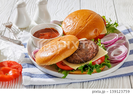 Beef cheeseburgers with brioche buns on a plate Beef cheeseburgers with brioche buns on a plate 139123759