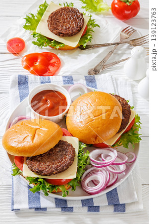 Beef cheeseburgers with brioche buns on a plate Beef cheeseburgers with brioche buns on a plate 139123763