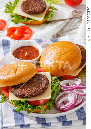 Beef cheeseburgers with brioche buns on a plate Beef cheeseburgers with brioche buns on a plate 139123764
