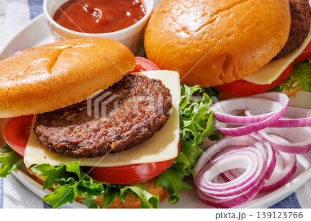 Beef cheeseburgers with brioche buns on a plate Beef cheeseburgers with brioche buns on a plate 139123766