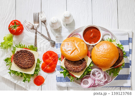 Beef cheeseburgers with brioche buns on a plate Beef cheeseburgers with brioche buns on a plate 139123768