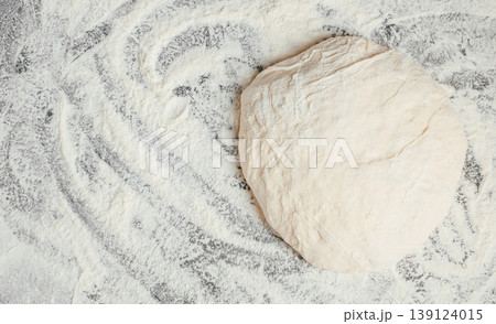 Raw dough on floured surface, top view with copy space 139124015
