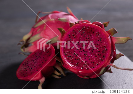 Dragon fruit on a grey granite background. Dragon fruit on a grey granite background. 139124128
