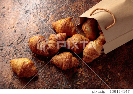 Fresh croissants on a brown vintage table. Fresh croissants on a brown vintage table. 139124147