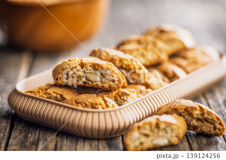 Crunchy Almond Biscotti cantuccini Stacked on Wooden Board With Tray of Italian Cookies for Coffee Time Crunchy Almond Biscotti cantuccini Stacked on Wooden Board With Tray of Italian Cookies for Coffee Time 139124256
