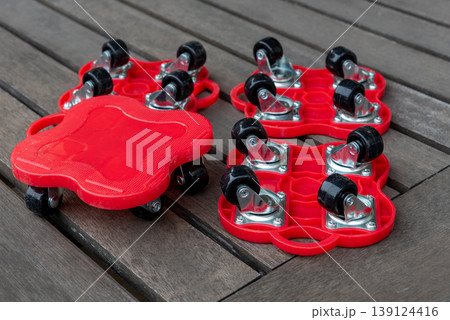 red plastic and metallic furniture moving rollers red plastic and metallic furniture moving rollers 139124416
