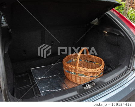 empty wicker shopping basket in the trunk of the car 139124418