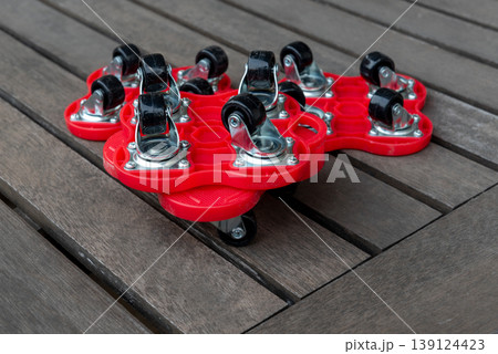 red plastic and metallic furniture moving rollers red plastic and metallic furniture moving rollers 139124423