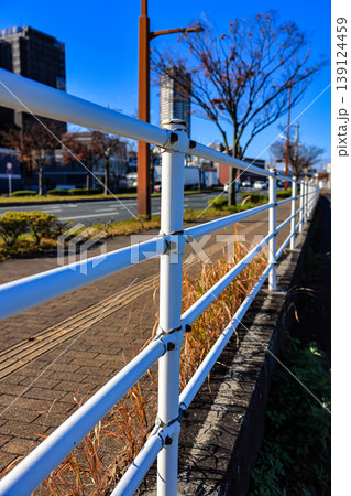 White steel fence along the walk way, close to the main road. White steel fence along the walk way, close to the main road. 139124459