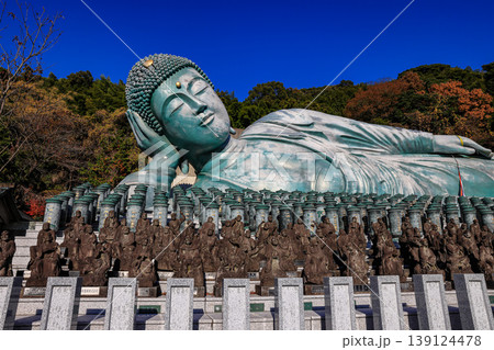The world's largest reclining bronze Buddha statue is at Nanzo-in Temple in Fukuoka Prefecture, Japan. In front of the Buddha image is a prayer cylinder etched with prayer. 139124478