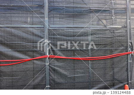 Covered facade of a reconstruction building, Scaffolding with safety nets during renovation building. 139124488