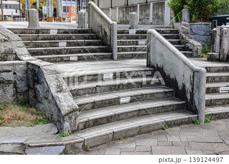 Gray stairs with traces of use, granite stairs, wide stone stairs, steps. Gray stairs with traces of use, granite stairs, wide stone stairs, steps. 139124497