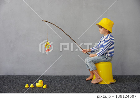 Happy child playing indoor. Kid enjoying a fishing trip. Little boy having fun at home Happy child playing indoor. Kid enjoying a fishing trip. Little boy having fun at home 139124607