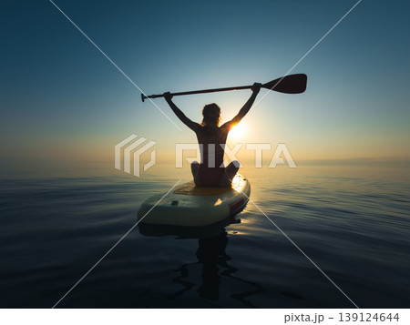 Young woman walking on sup board by the sea during summer vacation 139124644
