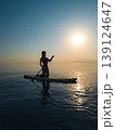 Young woman walking on sup board by the sea during summer vacation 139124647
